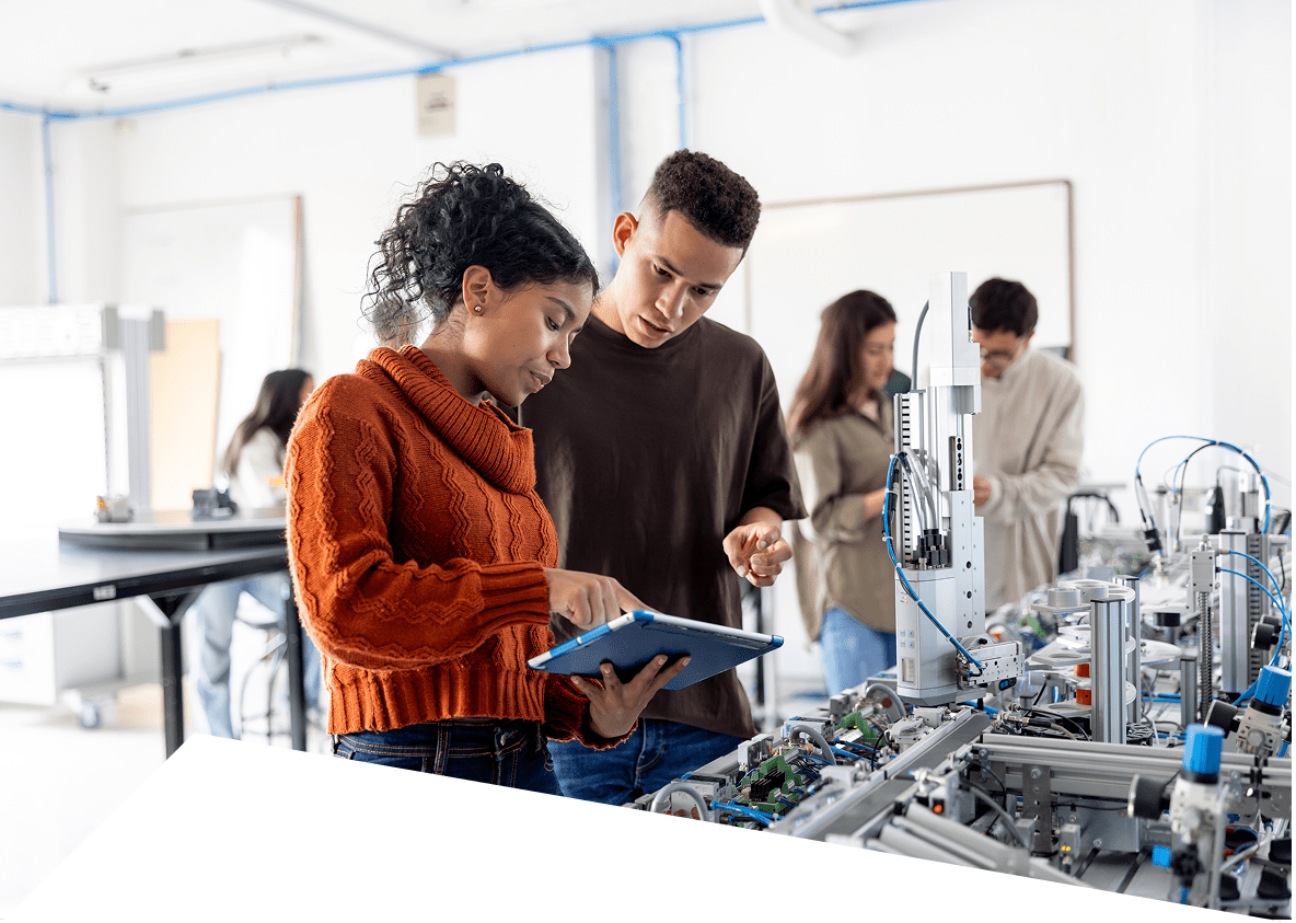 Collaborative engineering students with robotics equipment